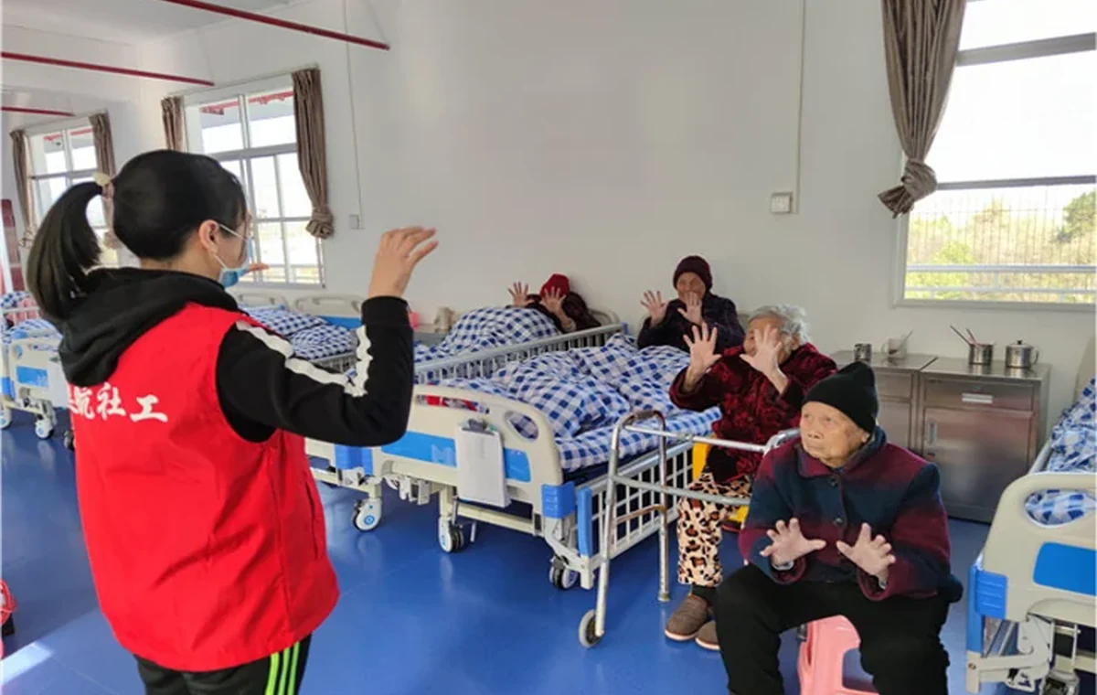 Eldercare room with patients and caregiver